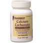Pharbest Calcium Carbonate 648 mg antacid and calcium supplement bottle with 100 tablets in a pharmacy setting.