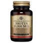 Solgar Super High Potency Biotin 10,000 mcg supplement in 60 vegetable capsules, stored in a clear bottle with a label.