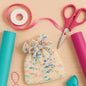 Darn Good Yarn Party Time Pouch knitting pattern for an easy beginner bag using sport weight silk yarn, with colorful knitted pouch design.
