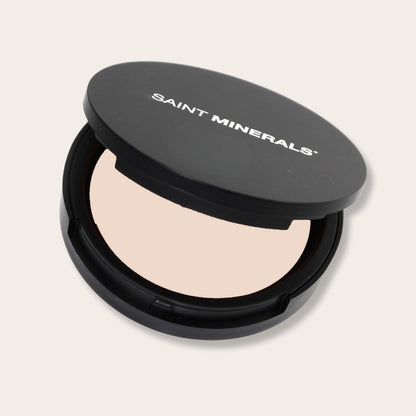 Close-up of SAINT MINERALS Pressed Powder Foundation in warm shade, showing smooth, pressed powder with a natural finish.