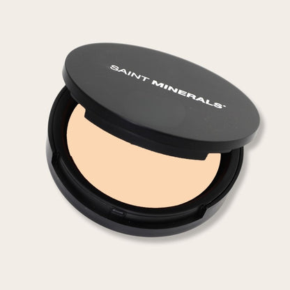Warm-toned pressed powder foundation by Panoply Beauty in sleek compact, showcasing smooth, finely milled texture.