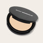 Pressed powder foundation by Saint Minerals in warm tone, showcasing the smooth, pressed makeup product with a natural finish.