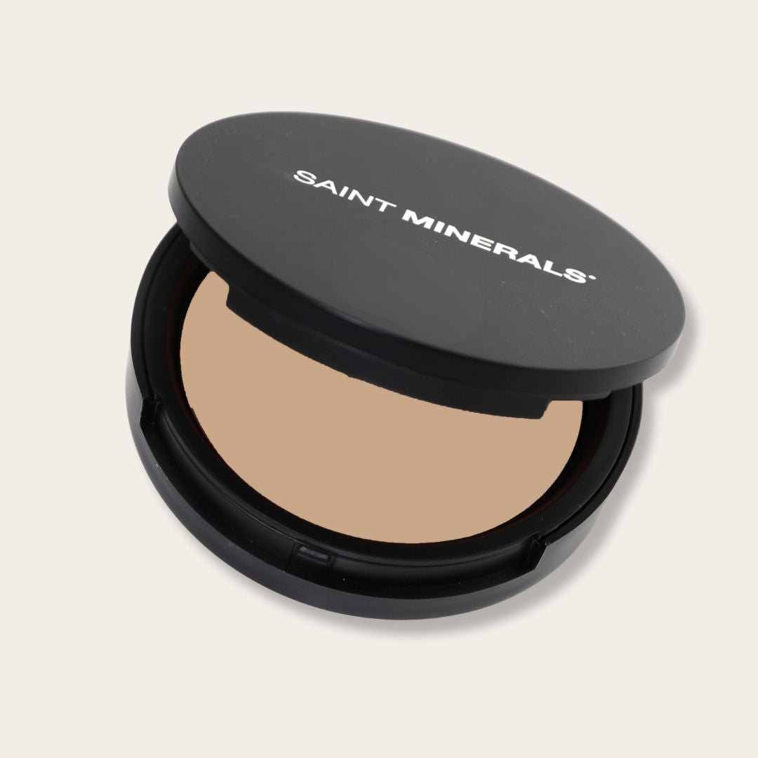 Pressed powder foundation by Saint Minerals in warm shade, showcasing smooth, pressed compact with natural finish.