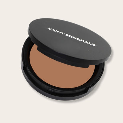 Pressed powder foundation by Saint Minerals in warm shade, with a smooth, matte finish perfect for daily makeup application.