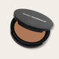 Pressed powder foundation by Saint Minerals in warm shade, with a smooth, matte finish perfect for daily makeup application.