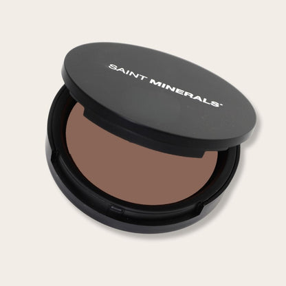 Pressed powder foundation by Panoply Beauty with warm-toned pressed powder in a compact.