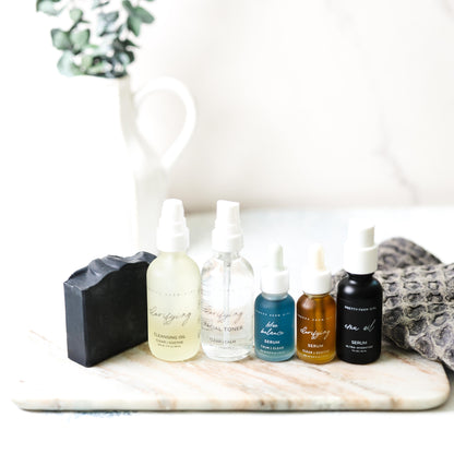 Pretty Farm Girl Acne Skin Kit bundle showing skincare products for full acne treatment routine in a natural setting.