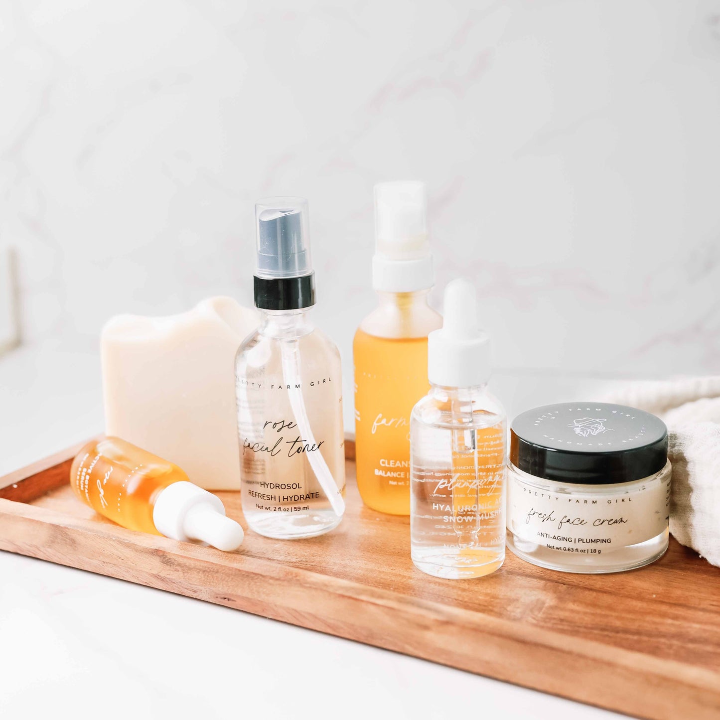 Pretty Farm Girl anti-aging skincare routine essentials kit bundle with cleansers, serums, and moisturizers in a natural skincare set.