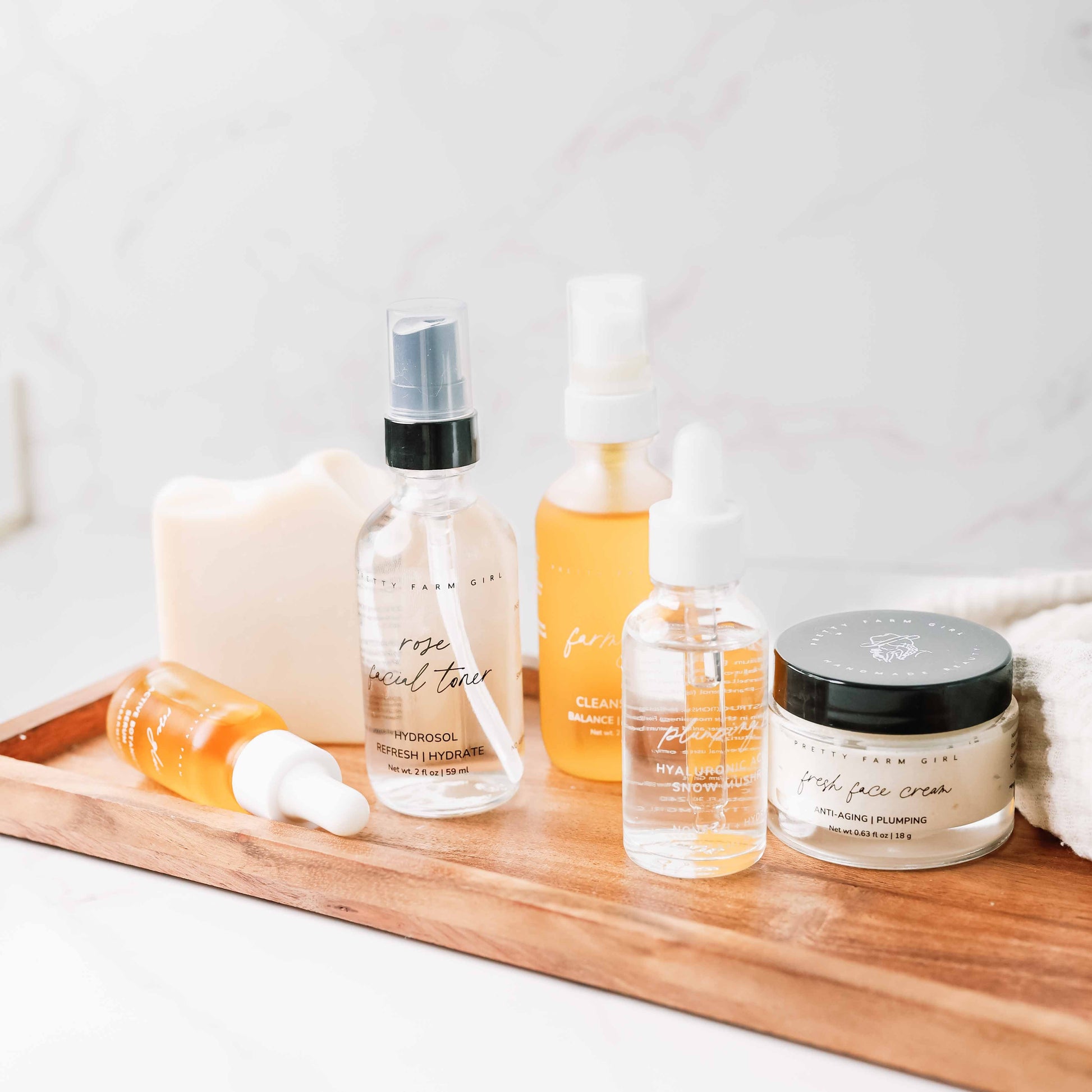 Pretty Farm Girl anti-aging skincare routine essentials kit bundle with cleansers, serums, and moisturizers in a natural skincare set.