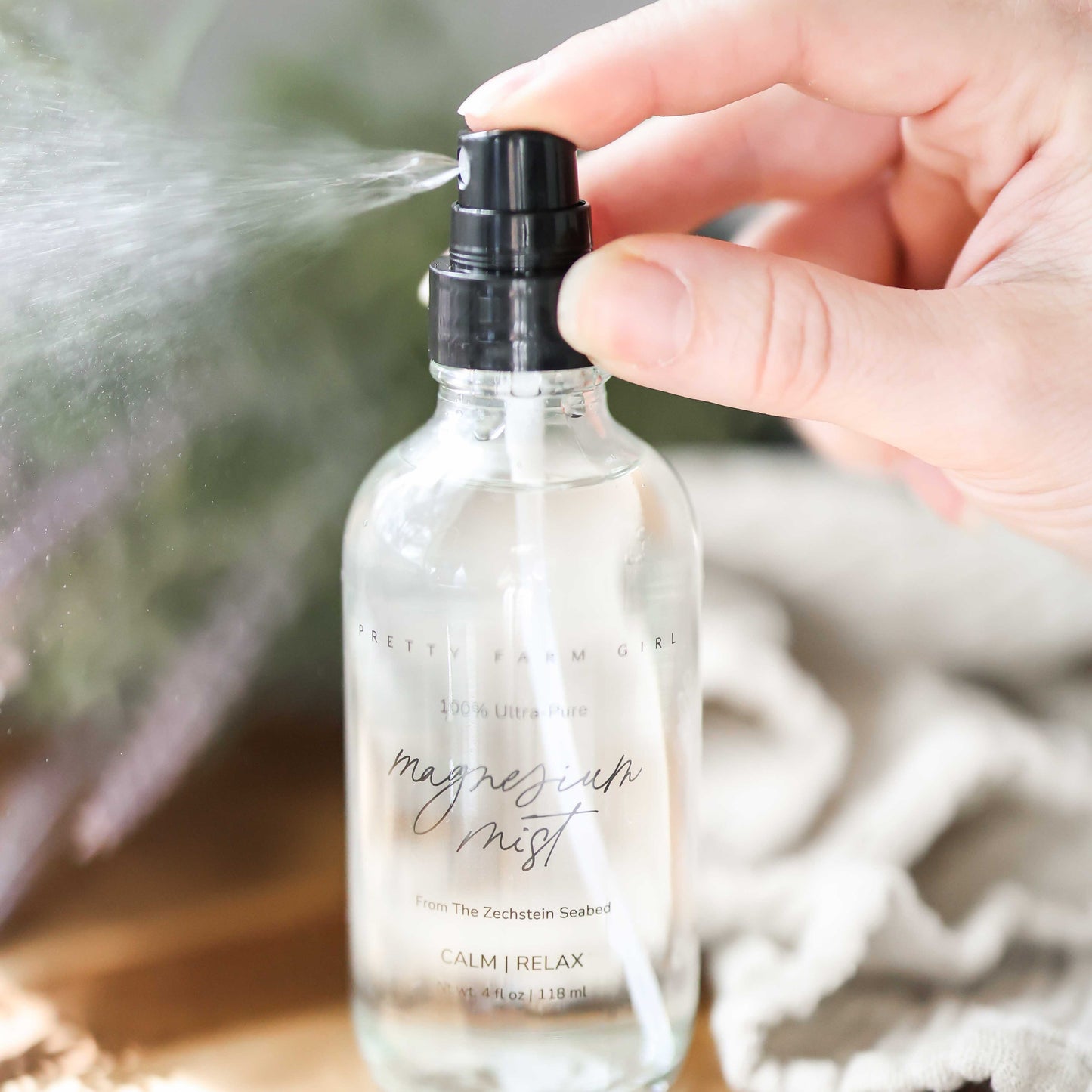 Pretty Farm Girl magnesium mist body spray toner in a spray bottle, designed for skin refreshment and relaxation.