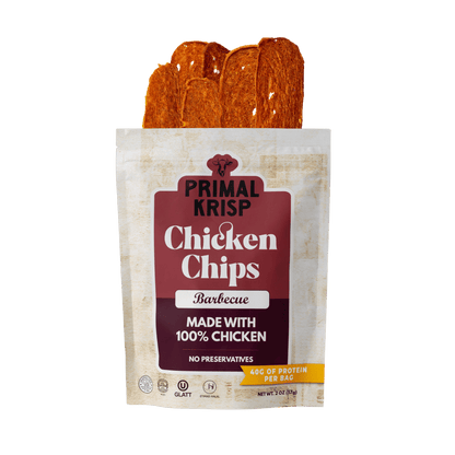 Primal Krisp BBQ Chicken 2oz snack bag showing crispy, seasoned chicken pieces with smoky barbecue flavor.