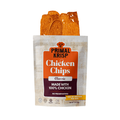 Primal Krisp Classic Chicken 2oz snack bag featuring crispy, seasoned chicken pieces in a resealable pouch.