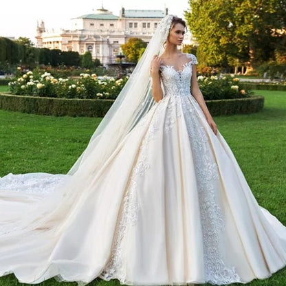 Elegant vintage cap sleeve luxury ball gown wedding dress by EdleessFashion, featuring intricate details and flowing fabric.
