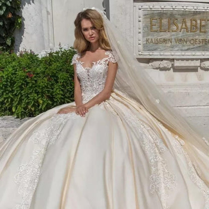 Elegant vintage cap sleeve luxury ball gown wedding dress by EdleessFashion, featuring intricate details and flowing fabric.