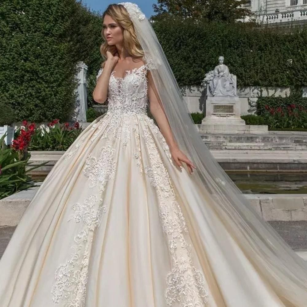 Elegant vintage cap sleeve luxury ball gown wedding dress by EdleessFashion, featuring intricate details and flowing fabric.