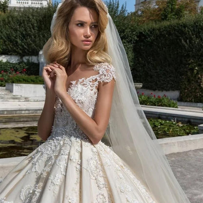Vintage cap sleeve luxury ball gown wedding dress by EdleessFashion, featuring intricate detailing and elegant fabric.