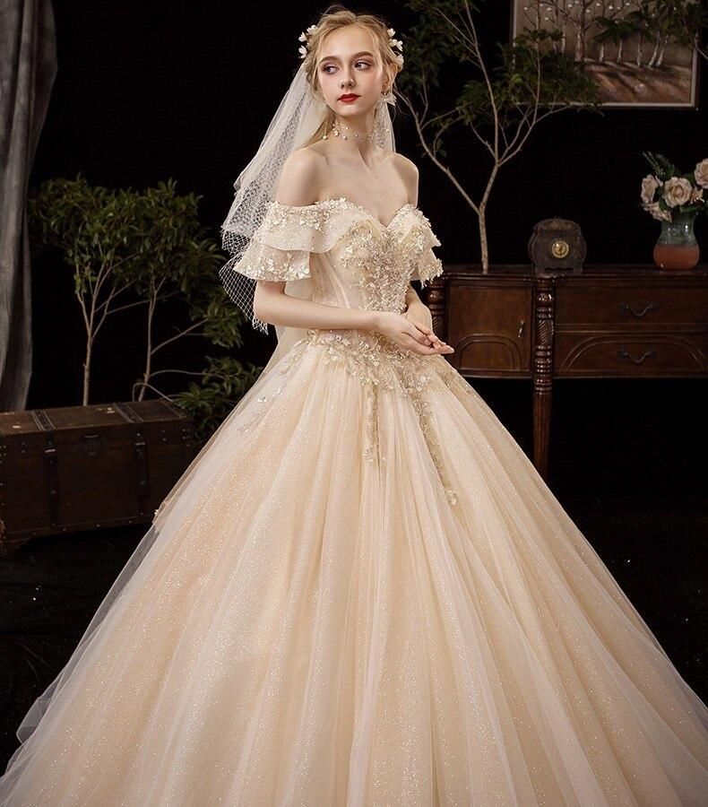 Shiny vintage off-shoulder wedding dress with crystal bead embellishments by EdleessFashion, luxurious bridal gown.