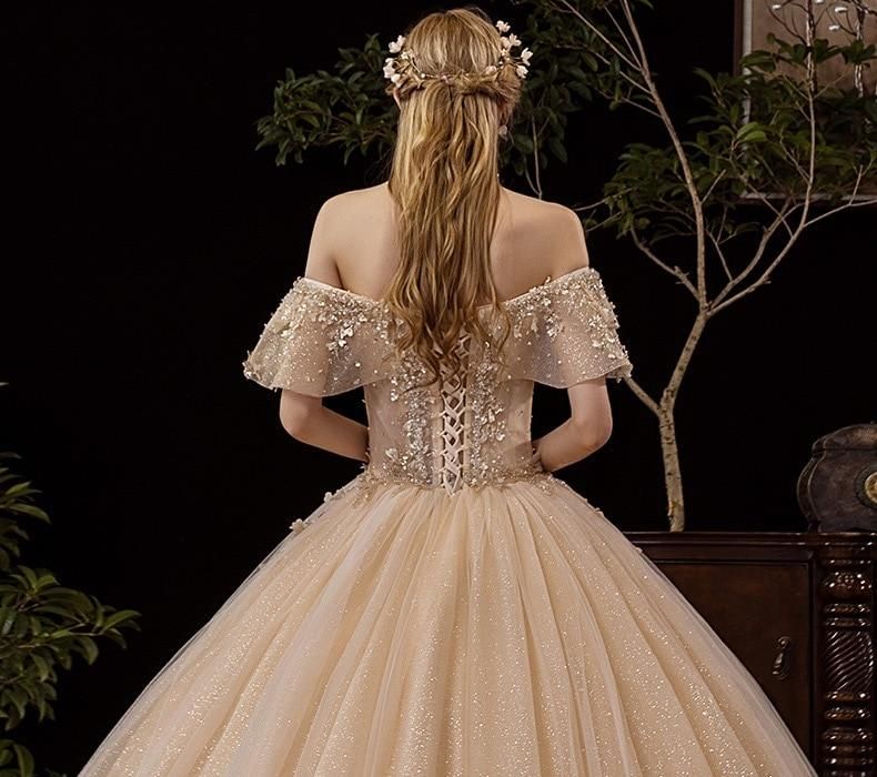 Shiny vintage off-shoulder wedding gown with crystal bead embellishments by EdleessFashion, luxurious bridal dress image.