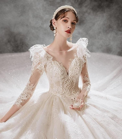 Luxurious princess wedding gown by EdleessFashion with shiny pearls, intricate lace details, and flowing train for a fairy-tale bridal look.