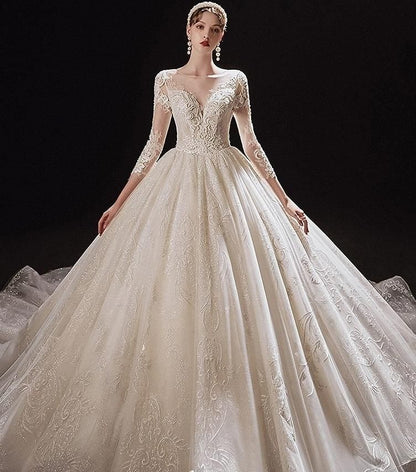 Luxurious princess wedding dress with shiny pearls by EdleessFashion, featuring intricate beadwork and flowing fabric.