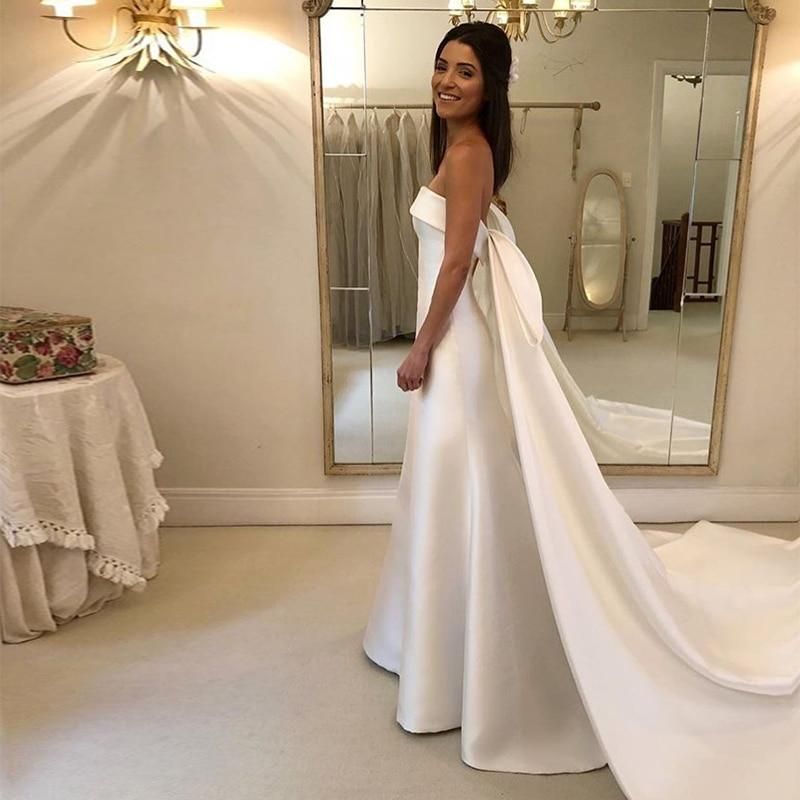 Elegant satin A-line wedding dress with strapless design and chapel train by EdleessFashion, showcased on a mannequin.