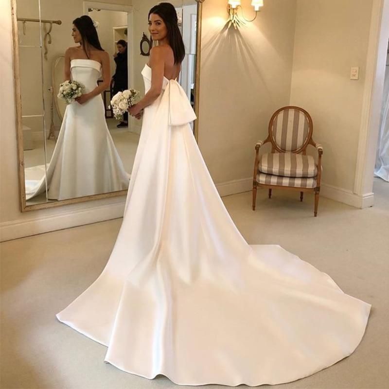 Elegant satin A-line wedding dress with strapless design and chapel train by EdleessFashion, shown on a model.