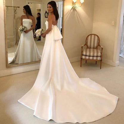 Elegant satin A-line wedding dress with strapless design and chapel train by EdleessFashion, shown on a model.
