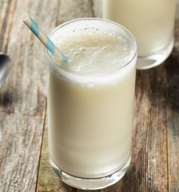 AmBari Nutrition Protidiet Vanilla Shake in a glass with a straw, showcasing a creamy vanilla-flavored protein shake.