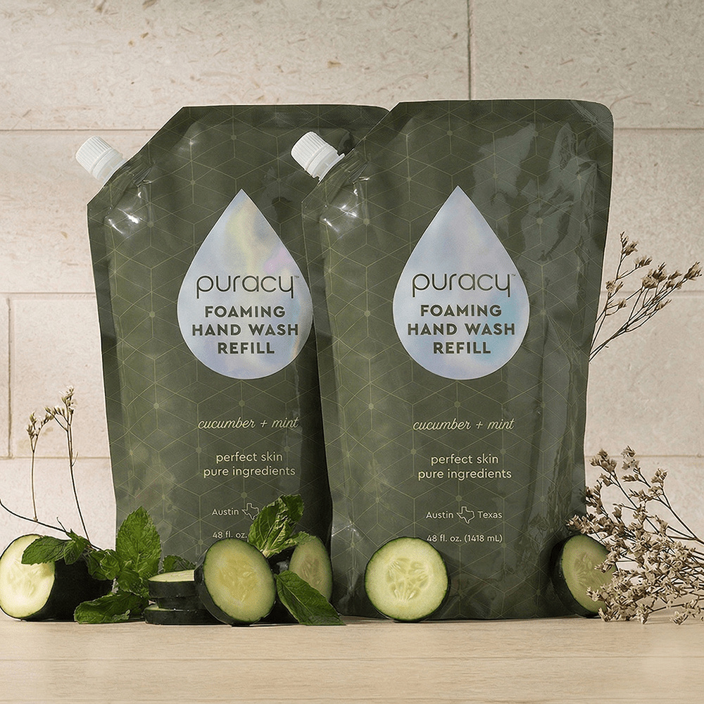 Set of three Puracy foaming hand soap bottles with lavender vanilla scent, featuring clean, minimalist pump bottles.