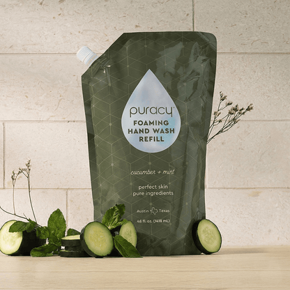 Puracy lavender vanilla foaming hand soap bottles, eco-friendly hand wash with natural scent, set of three on a bathroom sink.