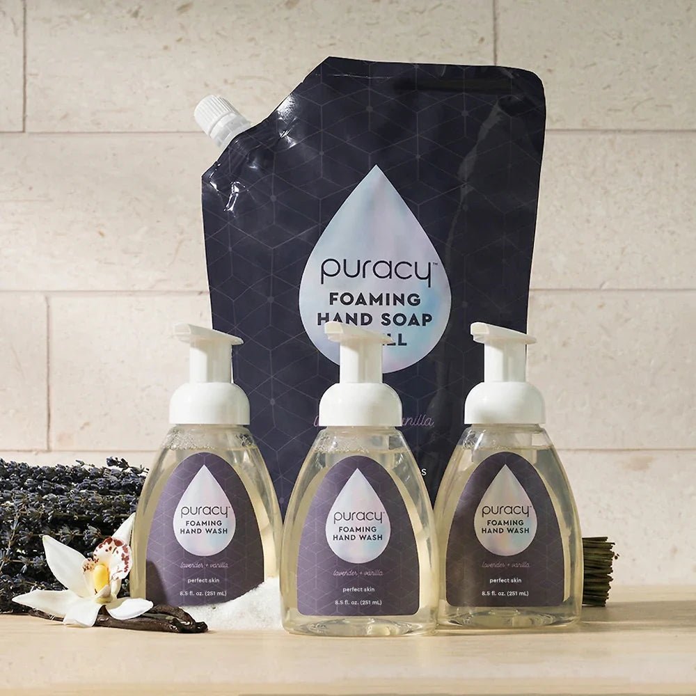 Set of three Puracy foaming hand soap bottles with lavender vanilla scent, featuring sleek pump dispensers and elegant labels.