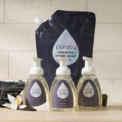 Set of three Puracy foaming hand soap bottles with lavender vanilla scent, featuring sleek pump dispensers and elegant labels.