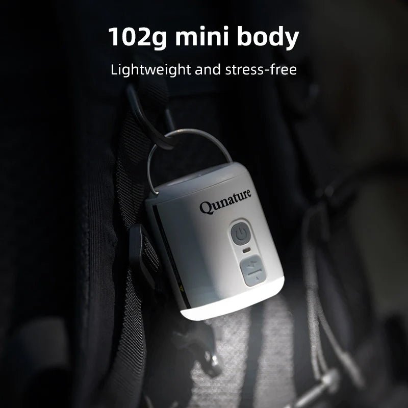 Qunature Global mini air pump with 4.5KPa pressure, 1600mAh battery, and built-in camping light in white.