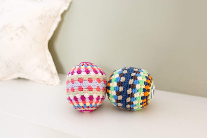 Colorful rainbow rattle ball toy made of handmade organic cotton by Bebemoss, perfect for babies and sensory play.