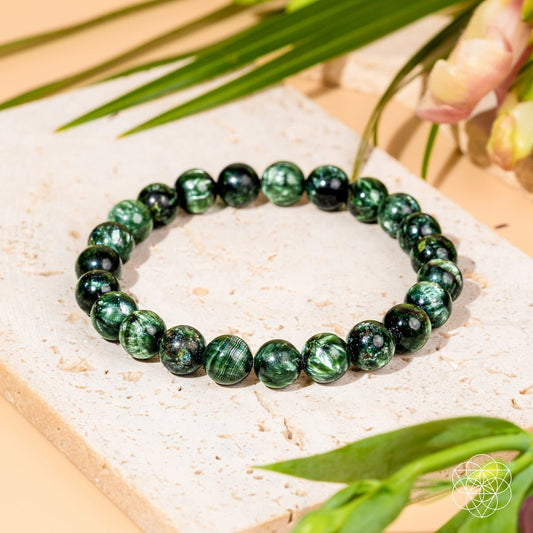 Rare Seraphinite bracelet by Conscious Items featuring green and silver-toned beads, showcasing a unique, polished gemstone design.
