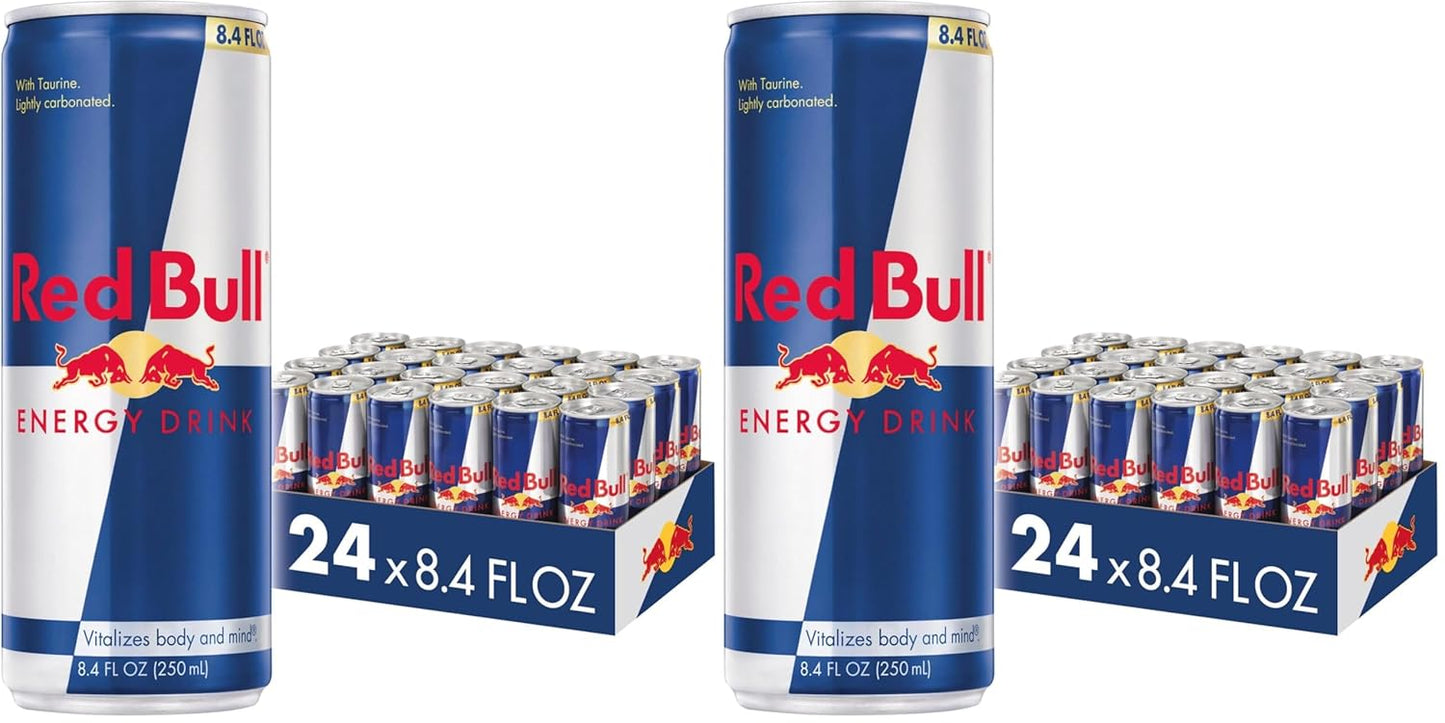 Six packs of four Red Bull Energy Drink cans, 8.4 fl oz each, with red and silver can design and branding visible.
