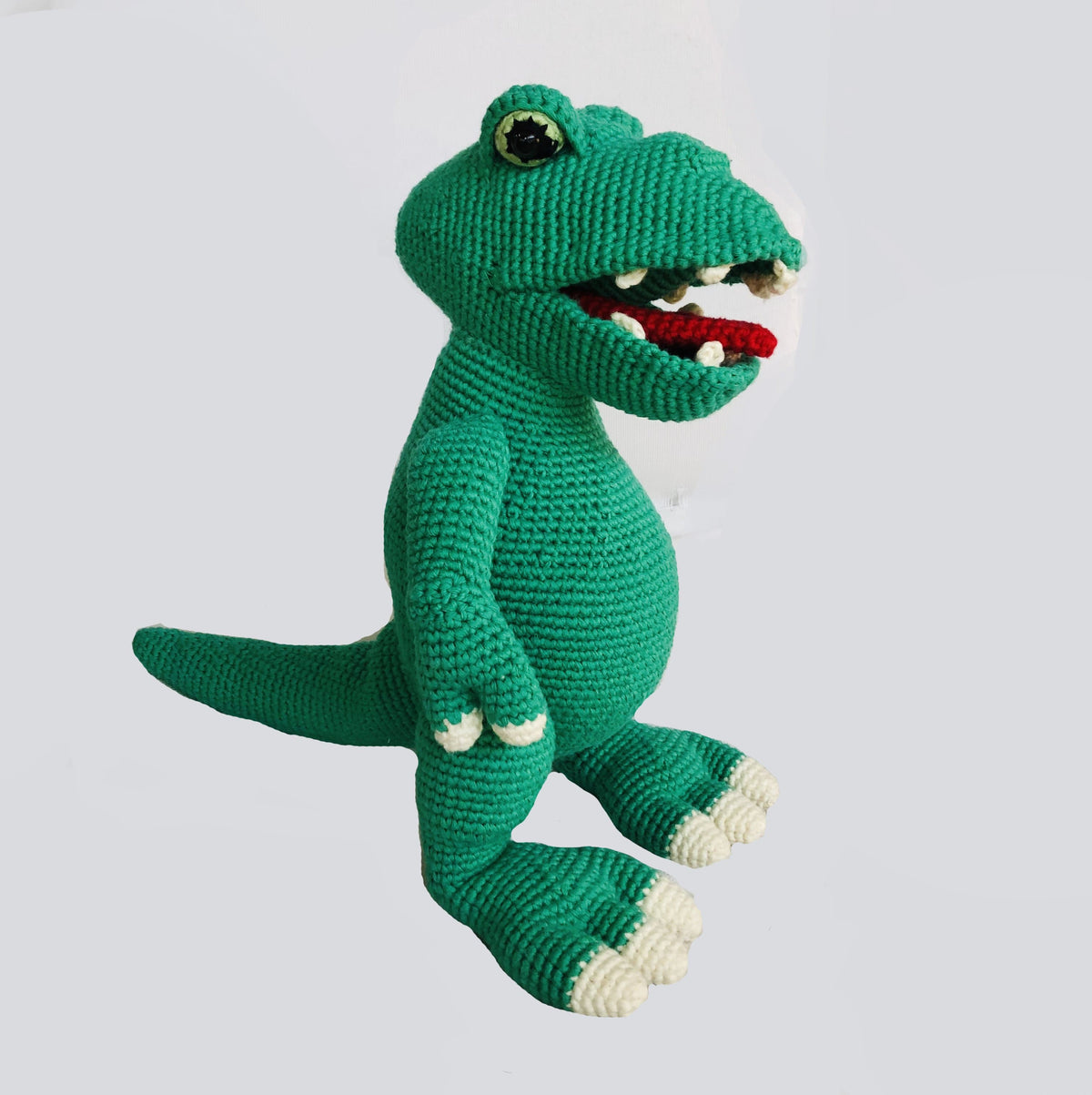 Handmade Rex the Dino stuffed animal by Bebemoss, made from organic cotton with detailed plush features.