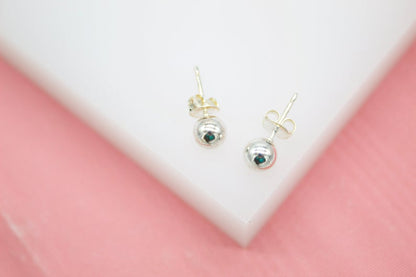 Rhodium-plated 18K gold filled tiny ball stud earrings by MIA Jewelry on a white background.