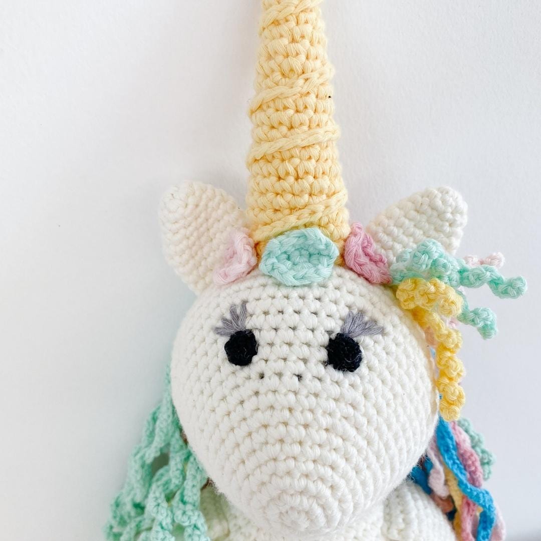 Handmade organic cotton stuffed unicorn named Rose by Bebemoss, featuring soft pastel colors and a whimsical design.
