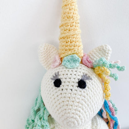 Handmade organic cotton stuffed unicorn named Rose by Bebemoss, featuring soft pastel colors and a whimsical design.