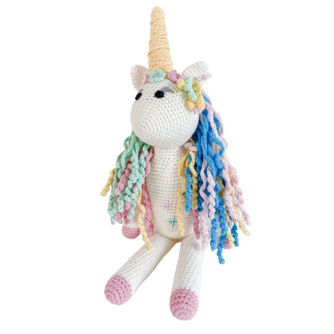 Handmade Rose the Unicorn stuffed animal made from organic cotton, featuring soft pastel colors and a friendly, whimsical design.