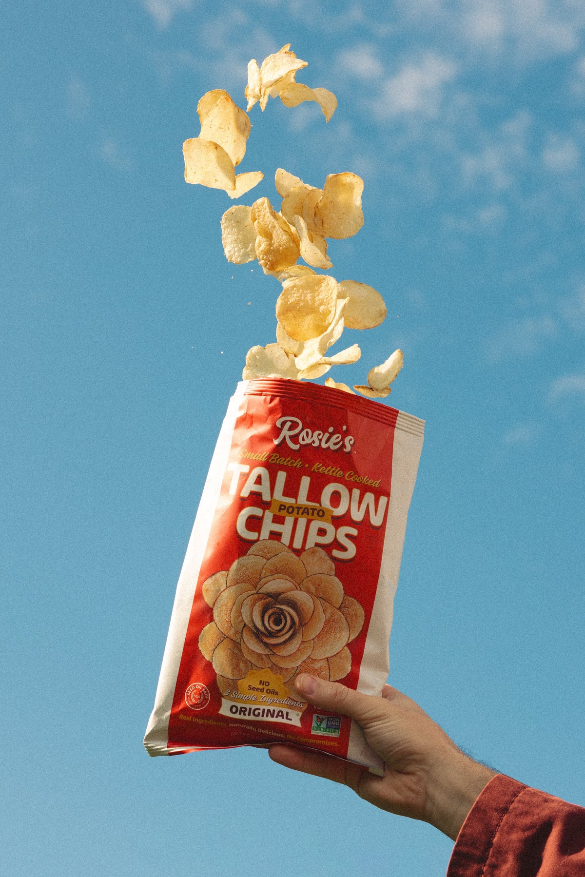 Golden, crispy potato chips from Rosie's Chips in a bowl, showcasing their crunchy texture and classic snack appeal.