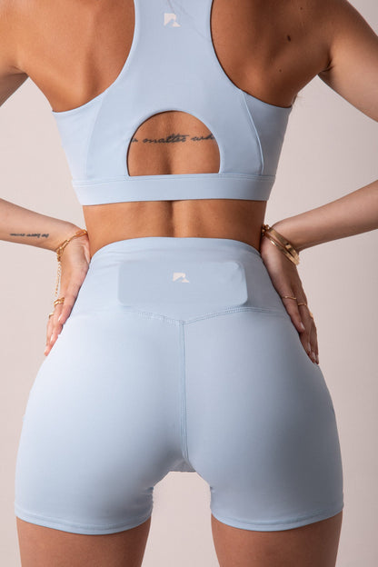 Women's LuxeForm Sculpting Workout Shorts by Runner's Athletics, 5-inch baby blue shorts with criss-cross waistband and pocket.