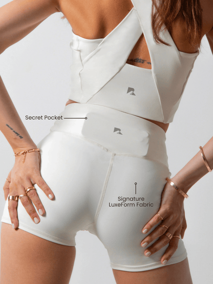 Women's LuxeForm Sculpting Workout Shorts by Runner's Athletics, 5-inch beige shorts with criss-cross waistband and pocket.