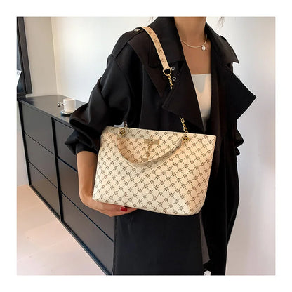 White luxury women's crossbody handbag with soft leather texture, large capacity tote, hanging accessories, and shoulder strap.