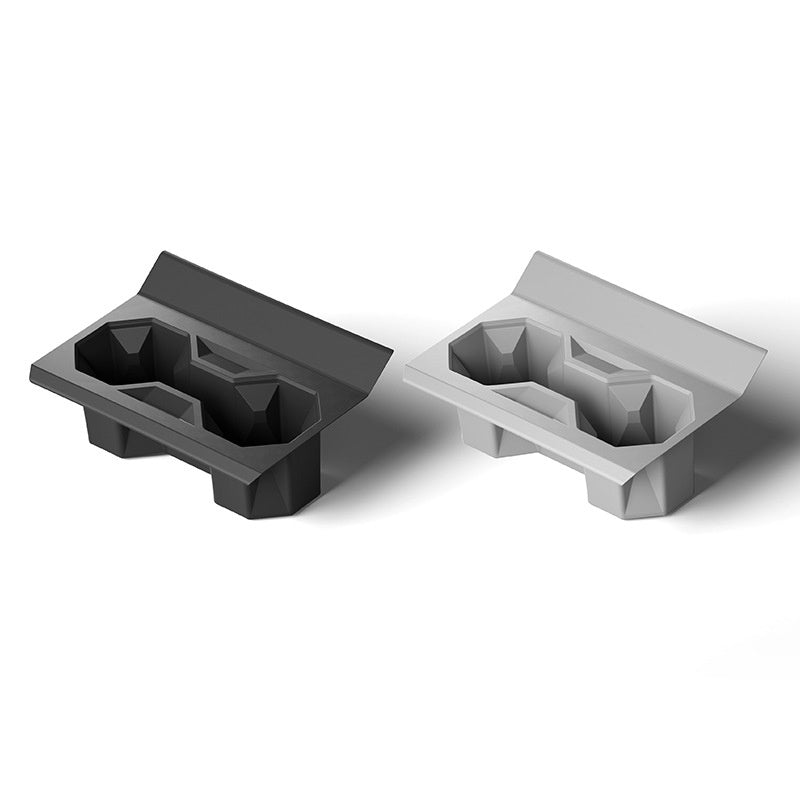 Silicone center console cup holder designed for Tesla Cybertruck, black and fitted to hold drinks securely in the vehicle interior.