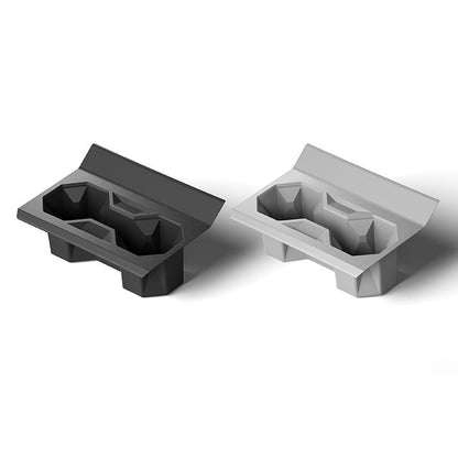 Silicone center console cup holder designed for Tesla Cybertruck, black and fitted to hold drinks securely in the vehicle interior.