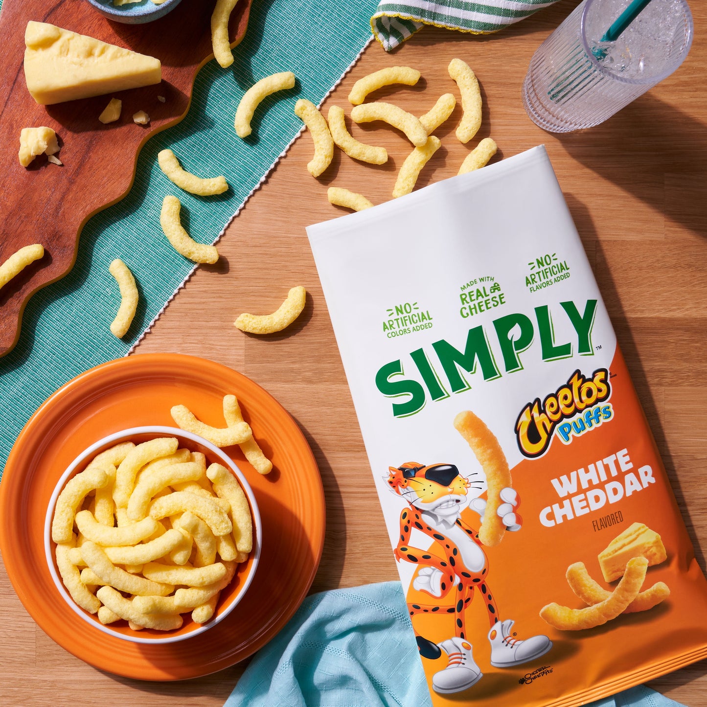 Simply Cheetos Puffs White Cheddar Cheese flavored snack chips in 0.875 oz bags, 36-count multipack, crispy cheesy snack.
