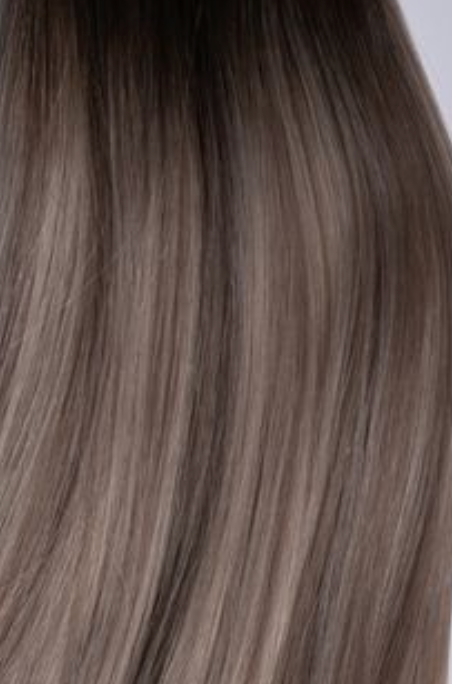 Rachel Paige XO Luxury Signature Weft Collection hair extensions in a smoky, natural-looking color with soft, flowing strands.