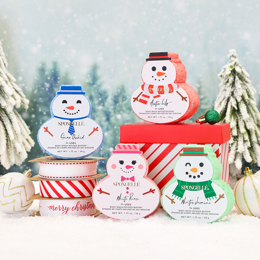Assorted holiday snowman-themed Spongellé body wash infused buffers arranged together, festive and colorful for holiday skincare.